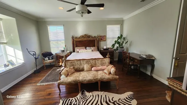 a bedroom with furniture and wooden floor