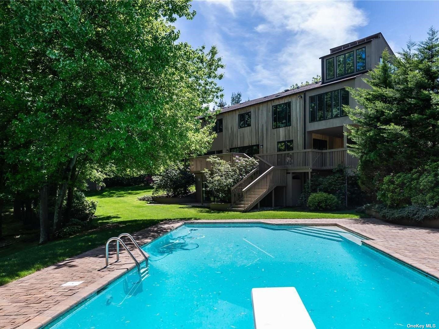 a view of a house with swimming pool and yard