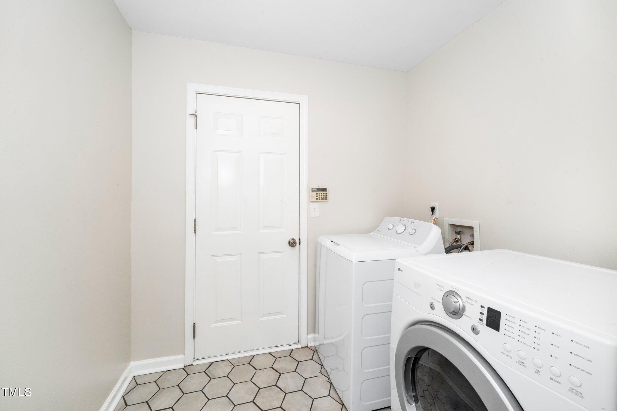 248 Inkster Cove Raleigh, NC 27603 - Photo 12 of 32 a view of storage and utility room with washer and dryer
