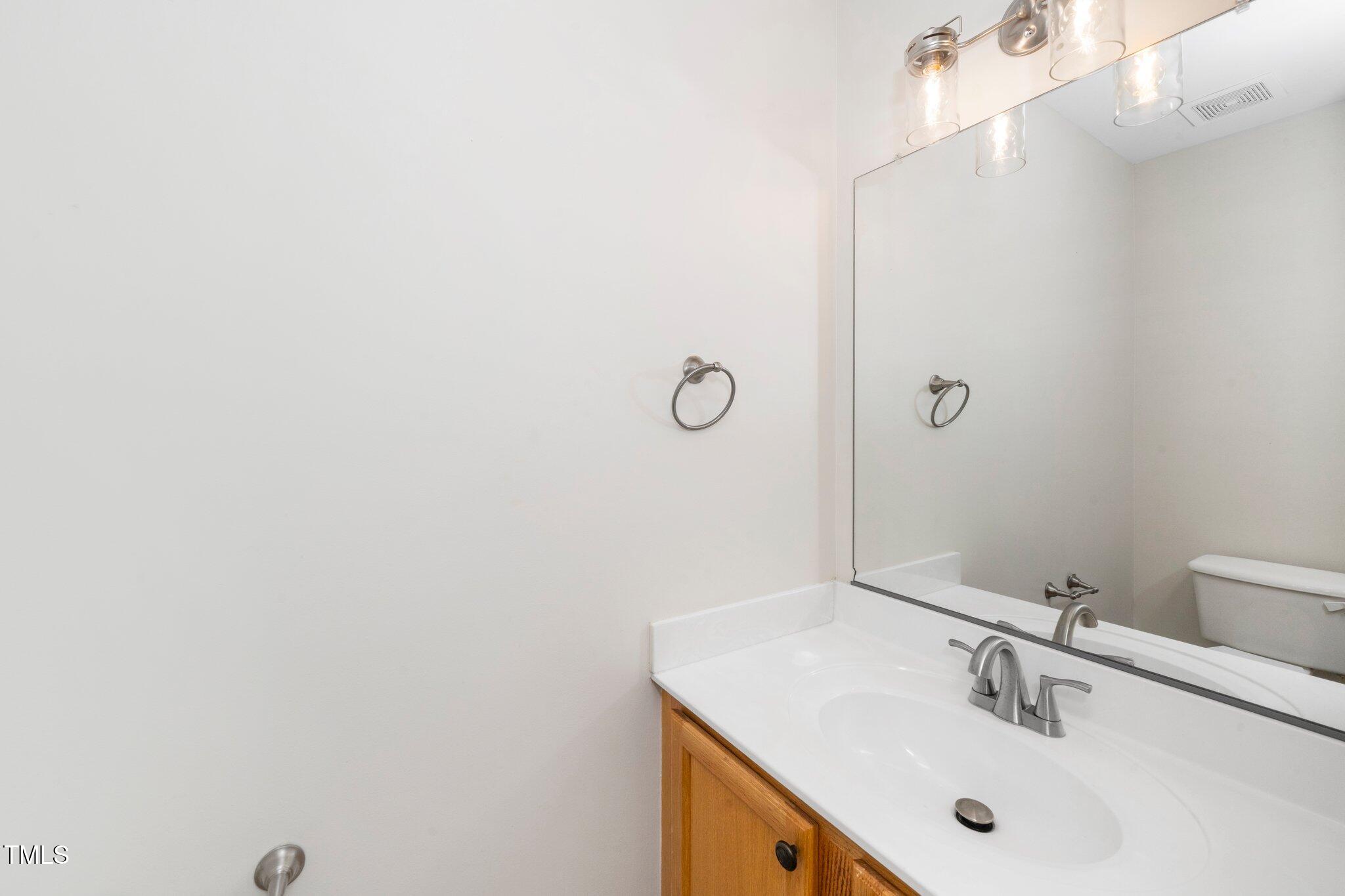 248 Inkster Cove Raleigh, NC 27603 - Photo 13 of 32 a bathroom with a sink and mirror