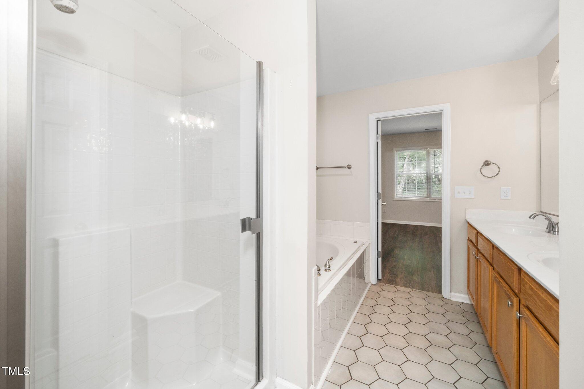 248 Inkster Cove Raleigh, NC 27603 - Photo 17 of 32 a bathroom with a double vanity sink and a mirror