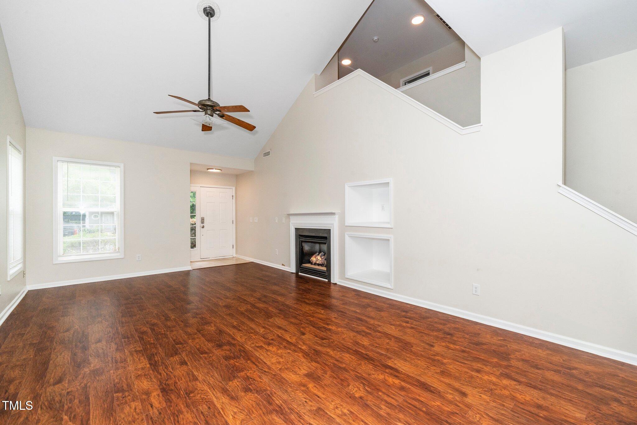 248 Inkster Cove Raleigh, NC 27603 - Photo 9 of 32 a view of empty room with wooden floor and fireplace