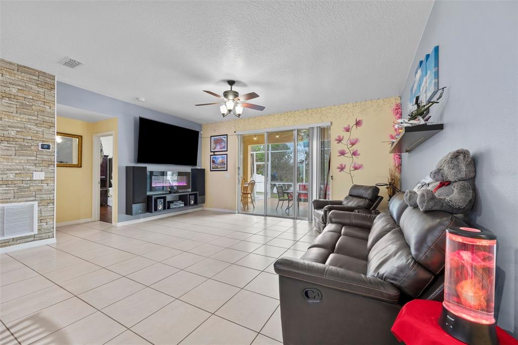 3409 Brant Street St. Cloud, FL 34772 - Photo 14 of 36 a living room with furniture and a flat screen tv