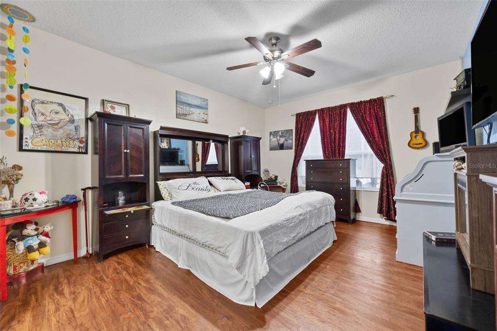 3409 Brant Street St. Cloud, FL 34772 - Photo 16 of 36 a bedroom with a bed and a chandelier