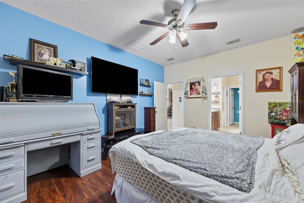 3409 Brant Street St. Cloud, FL 34772 - Photo 17 of 36 a bedroom with a bed and a flat screen tv