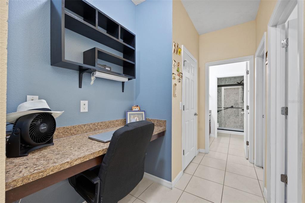 3409 Brant Street St. Cloud, FL 34772 - Photo 21 of 36 a bedroom with a bed and cabinets