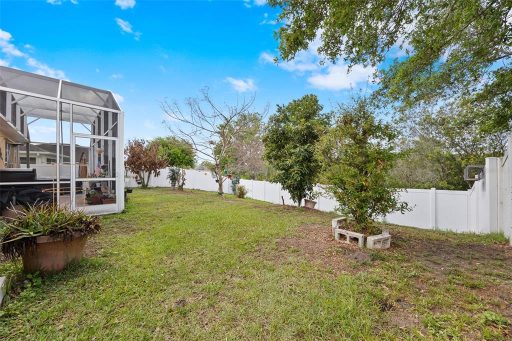 3409 Brant Street St. Cloud, FL 34772 - Photo 29 of 36 a backyard of a house with table and chairs