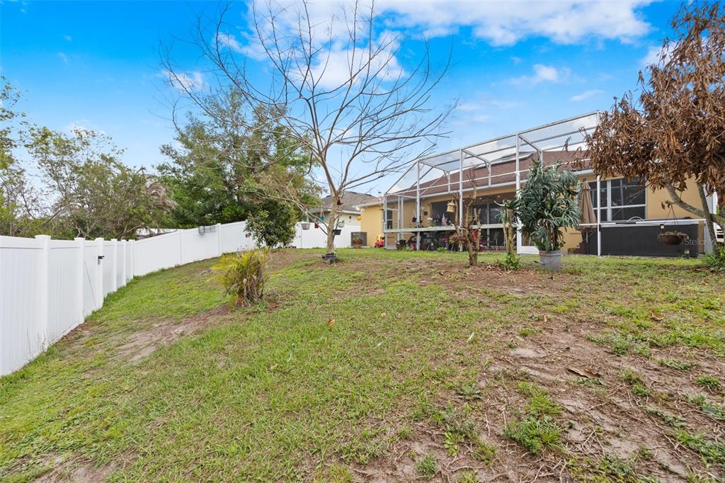 3409 Brant Street St. Cloud, FL 34772 - Photo 30 of 36 a view of a house with a yard