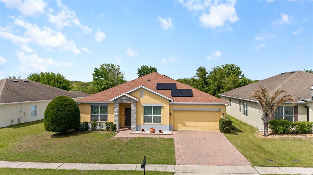 3409 Brant Street St. Cloud, FL 34772 - Photo 31 of 36 a front view of a house with a yard