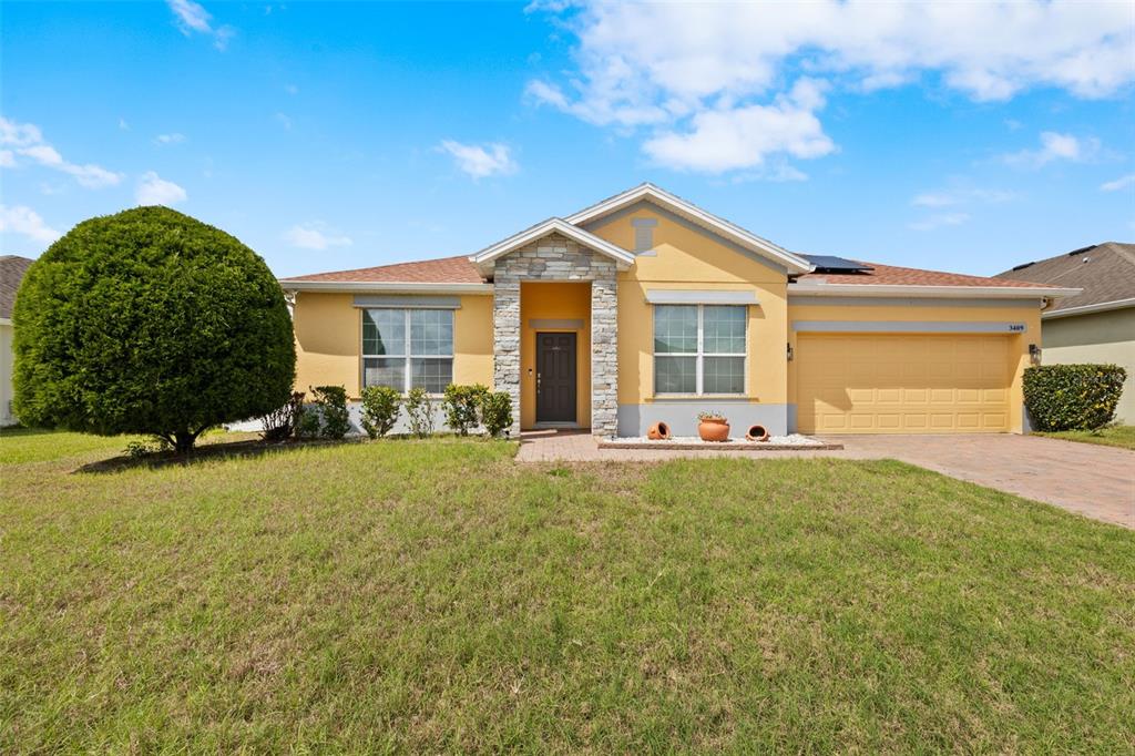 3409 Brant Street St. Cloud, FL 34772 - Photo 4 of 36 a front view of a house with a yard
