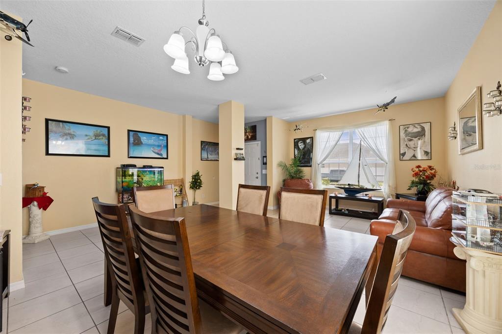 3409 Brant Street St. Cloud, FL 34772 - Photo 8 of 36 a view of a dining room with furniture and wooden floor