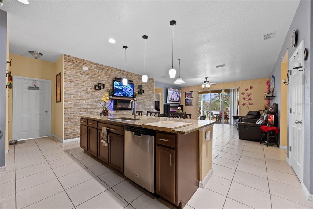 3409 Brant Street St. Cloud, FL 34772 - Photo 9 of 36 a kitchen with stainless steel appliances granite countertop a sink and cabinets