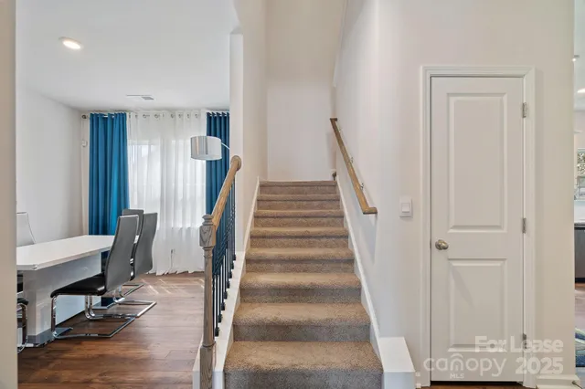 a view of entryway with wooden floor and stairs