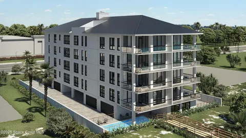 a front view of a building with a garden