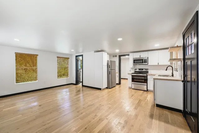 a kitchen with stainless steel appliances a refrigerator and a stove top oven