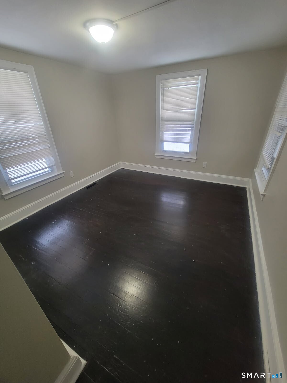 9 Harvard Street Waterbury, CT 06704 - Photo 2 of 4 a view of room with wooden floor and windows