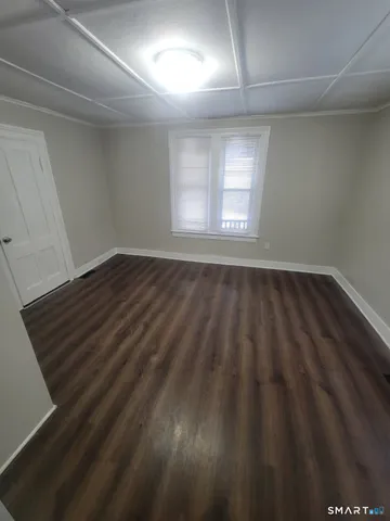 a view of an empty room and wooden floor