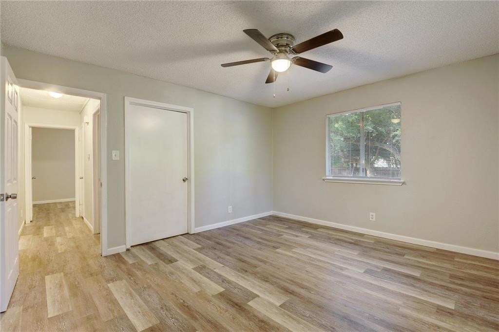 2311 Teri Road, Unit B Austin, TX 78744 - Photo 12 of 25 an empty room with wooden floor and windows