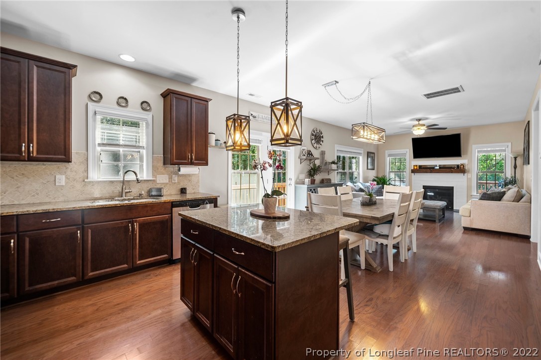 228 Culpepper Road Cameron, NC 28326 - Photo 14 of 36 a kitchen with stainless steel appliances granite countertop a stove and a view of living room