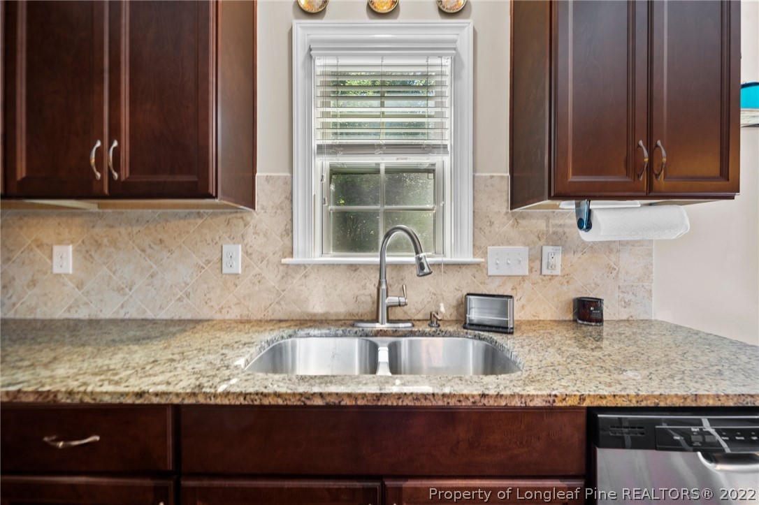 228 Culpepper Road Cameron, NC 28326 - Photo 16 of 36 a kitchen with granite countertop a sink window and cabinets