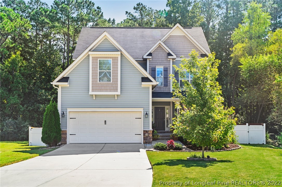 228 Culpepper Road Cameron, NC 28326 - Photo 2 of 36 a view of a yard in front of a house with plants and large tree