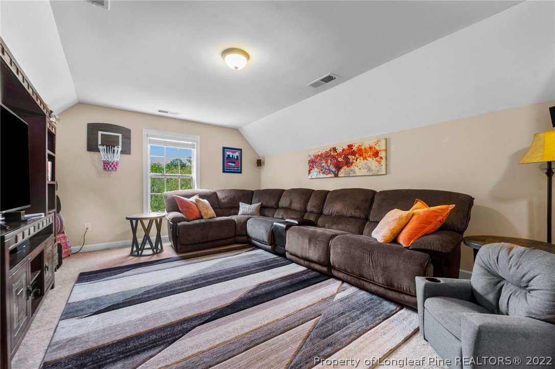 228 Culpepper Road Cameron, NC 28326 - Photo 28 of 36 a living room with furniture and a flat screen tv