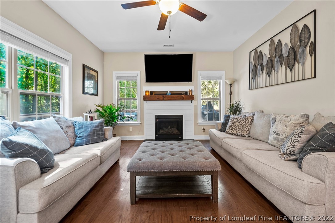 228 Culpepper Road Cameron, NC 28326 - Photo 10 of 36 a living room with furniture a flat screen tv and a fireplace
