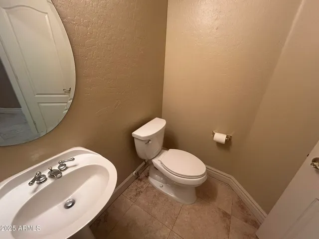 an empty room with windows and ceiling fan view