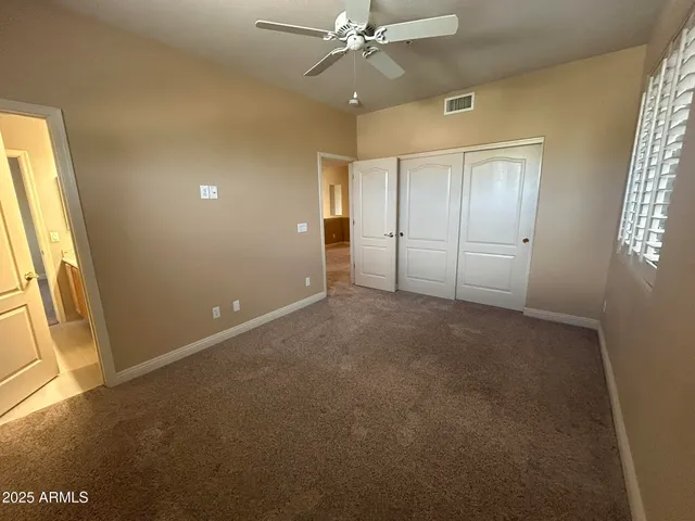 a bathroom with a granite countertop double vanity sink and a mirror