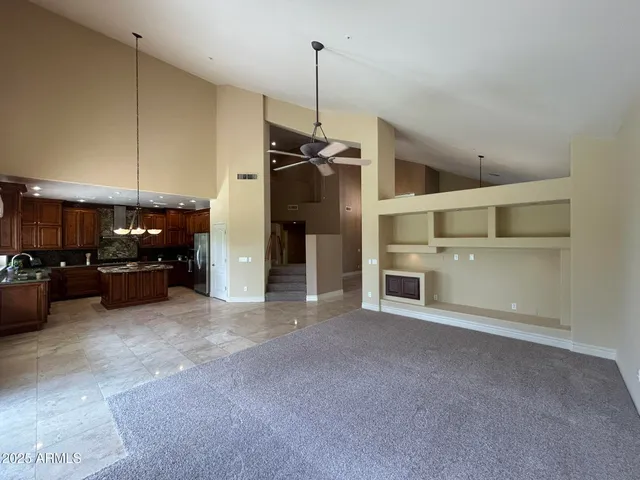 a kitchen with kitchen island granite countertop wooden cabinets and a sink