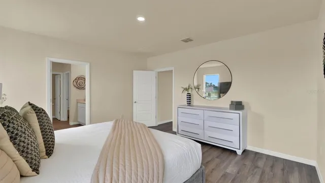 a bedroom with a bed and a dresser