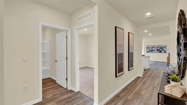 a view of a hallway with wooden floor and entryway