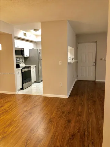 a view of a kitchen cabinets and wooden floor