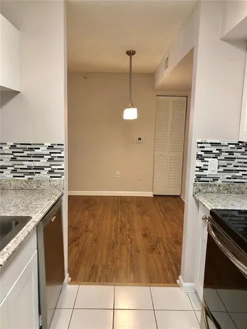 a kitchen with granite countertop a sink and a stove