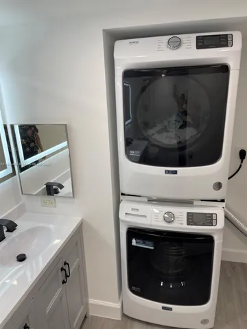 a utility room with a stove and a sink