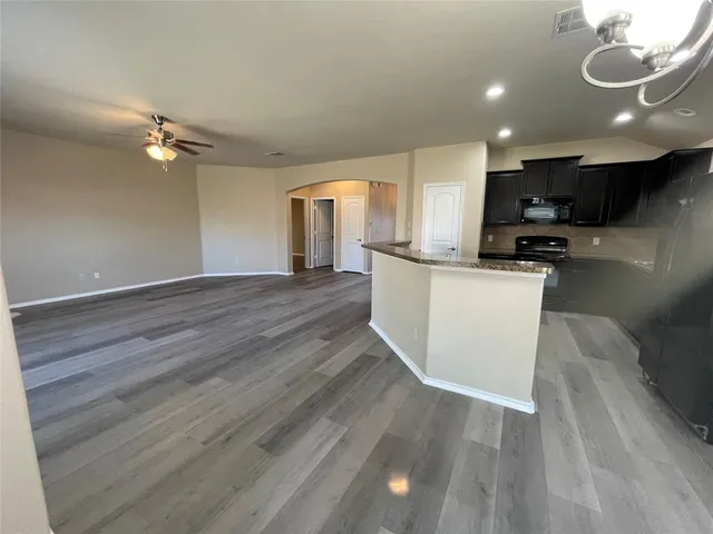 a view of a field with an house in background