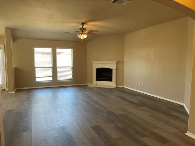 a kitchen with stainless steel appliances granite countertop a sink a stove and a wooden floors