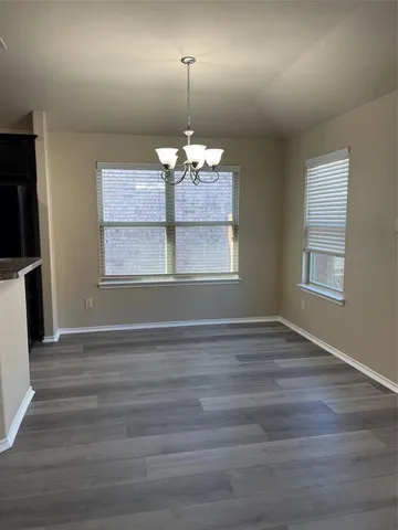 a kitchen with granite countertop a refrigerator and a sink