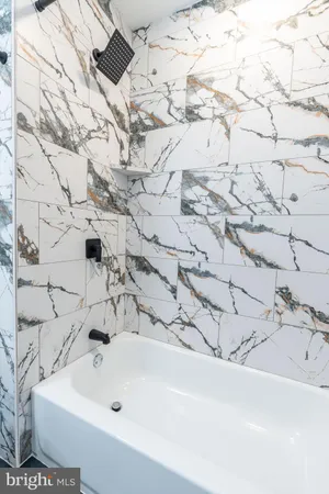 a bathroom with a bathtub and shower