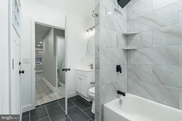 a bathroom with a bathtub and a shower