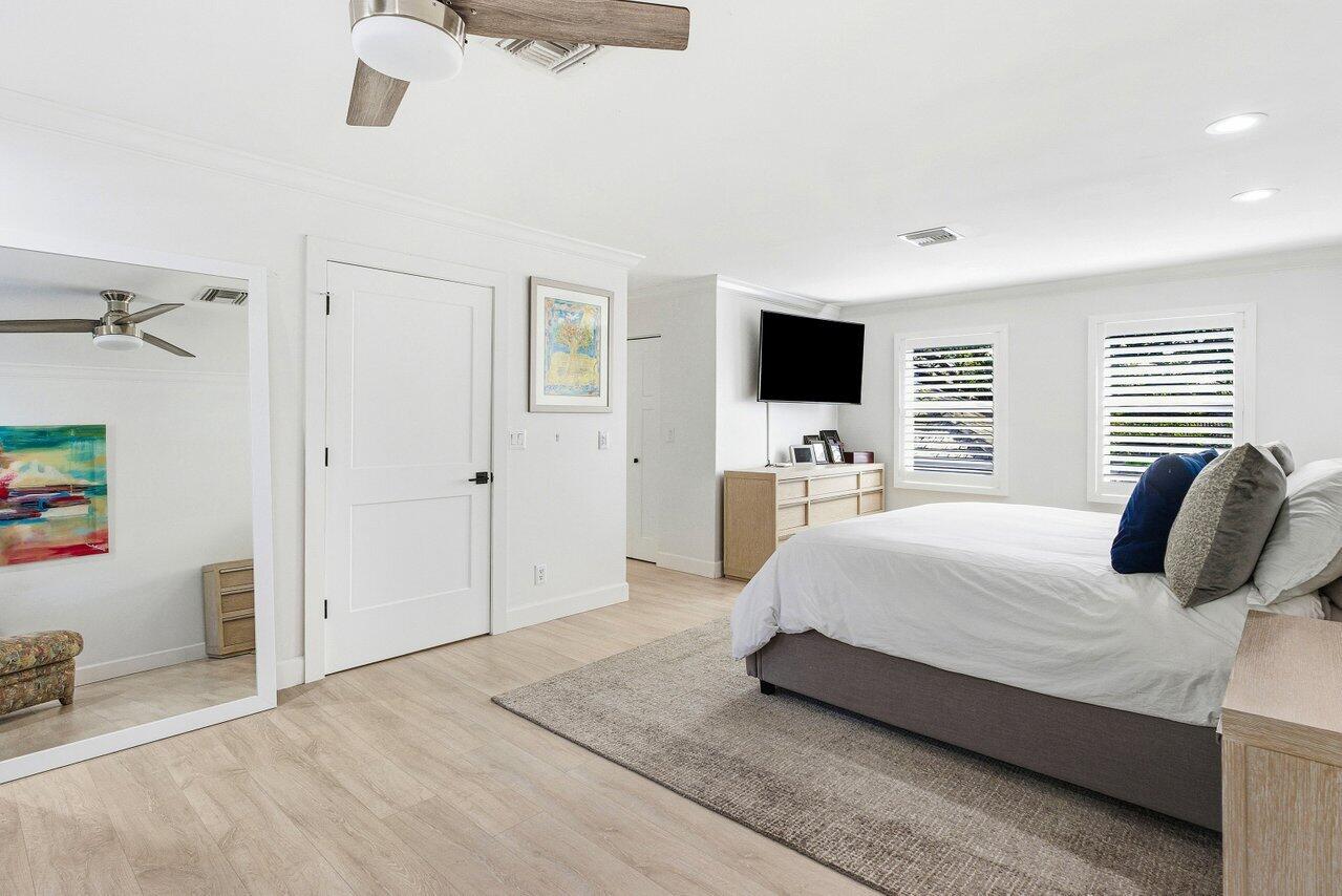 5696 Northwest 39th Avenue Boca Raton, FL 33496 - Photo 14 of 24 a bedroom with a bed and a flat screen tv