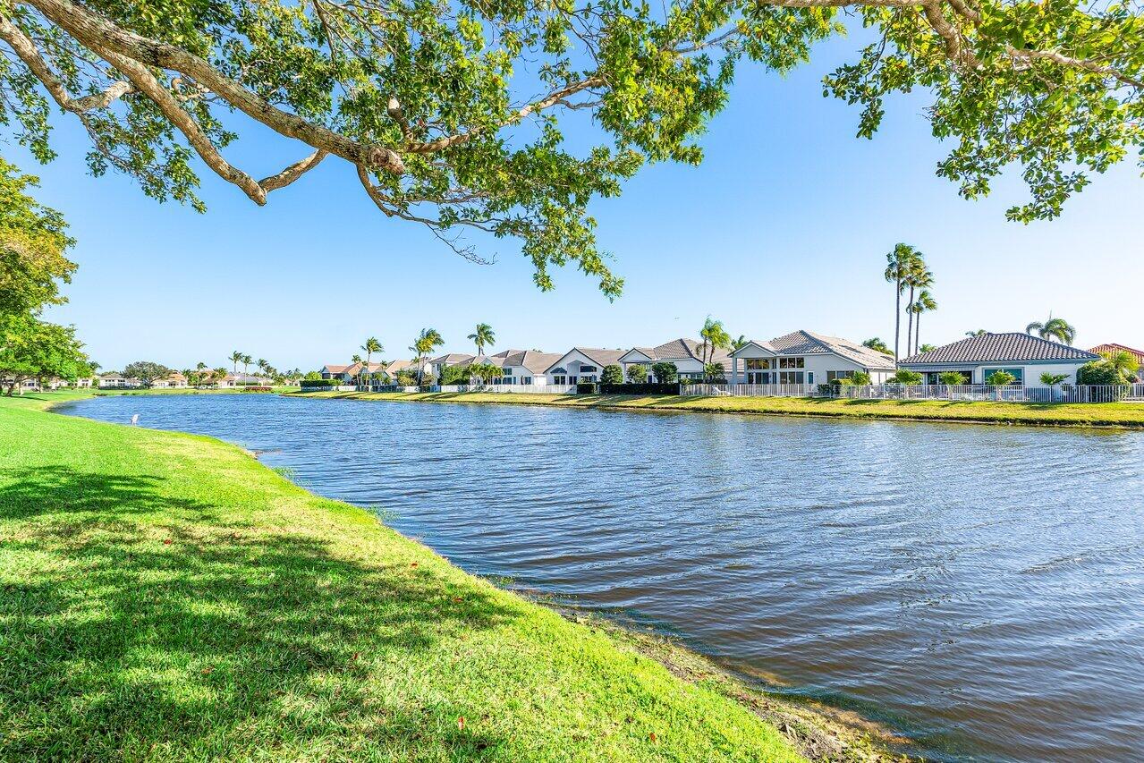 5696 Northwest 39th Avenue Boca Raton, FL 33496 - Photo 22 of 24 a view of a lake with houses