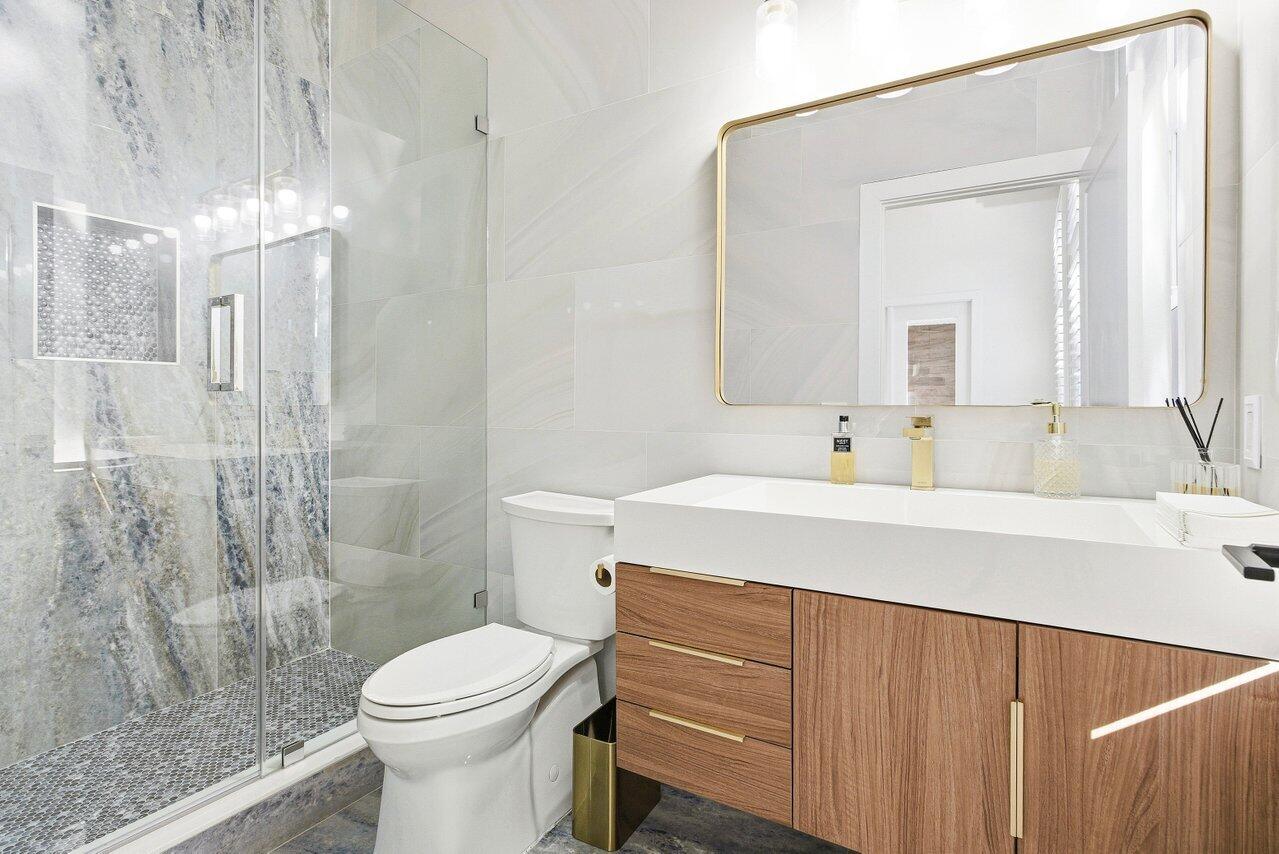 5696 Northwest 39th Avenue Boca Raton, FL 33496 - Photo 8 of 24 a bathroom with a sink a toilet and shower