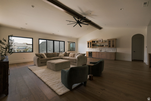 2281 South Crimson Cliffs Way St. George, UT 84790 - Photo 29 of 47 Living area featuring arched walkways, dark wood-style flooring, a ceiling fan, beamed ceiling, and beverage cooler