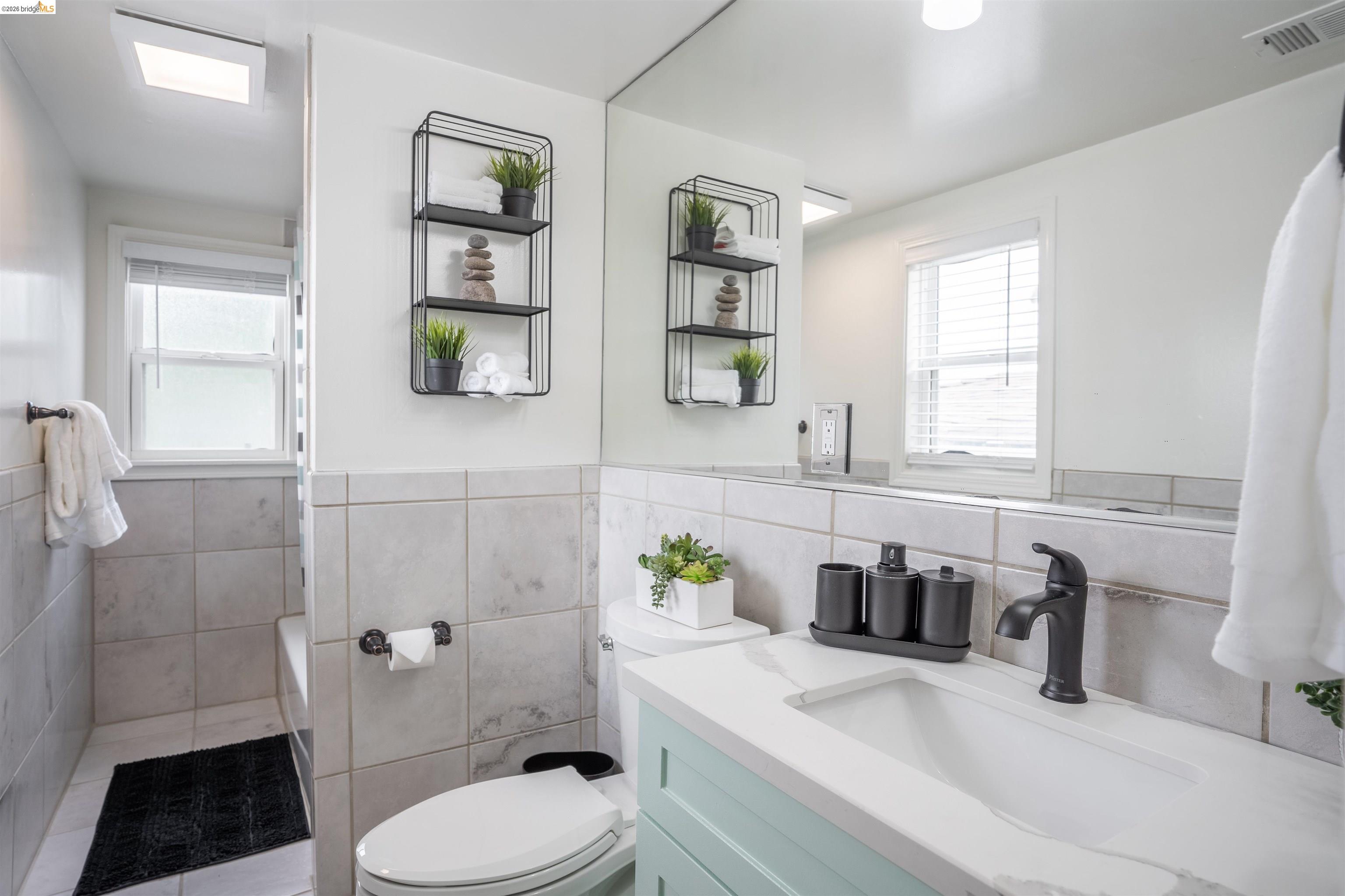 527 Chester Street Oakland, CA 94607 - Photo 44 of 47 527 (Upstairs) Full bath featuring vanity and tile walls