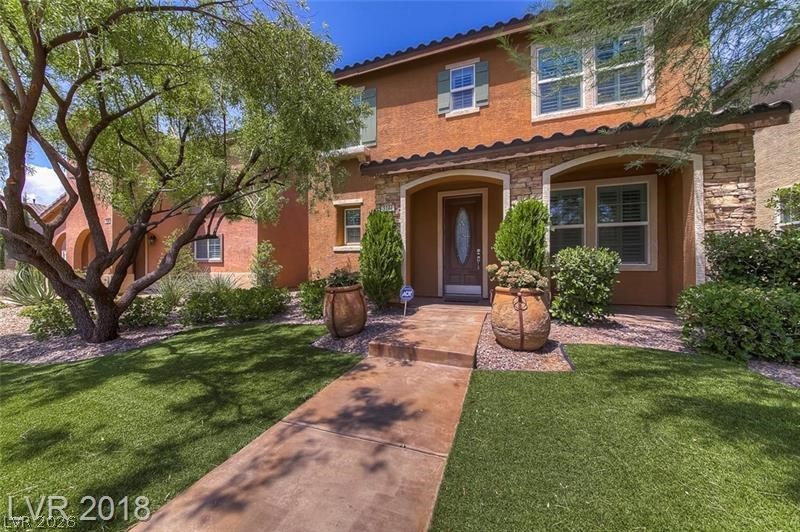 3144 Whitfeild Avenue Henderson, NV 89044 - Photo 1 of 55 A terracotta-hued exterior with stone accents and a manicured lawn creates inviting curb appeal.