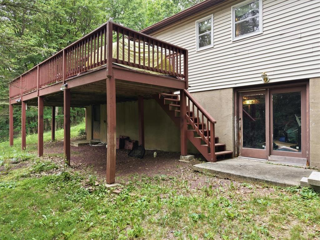 520 Highland Hill Road Jim Thorpe, PA 18235 - Photo 51 of 83 A spacious elevated deck with stairs provides outdoor living space, complementing the home's rear exterior.