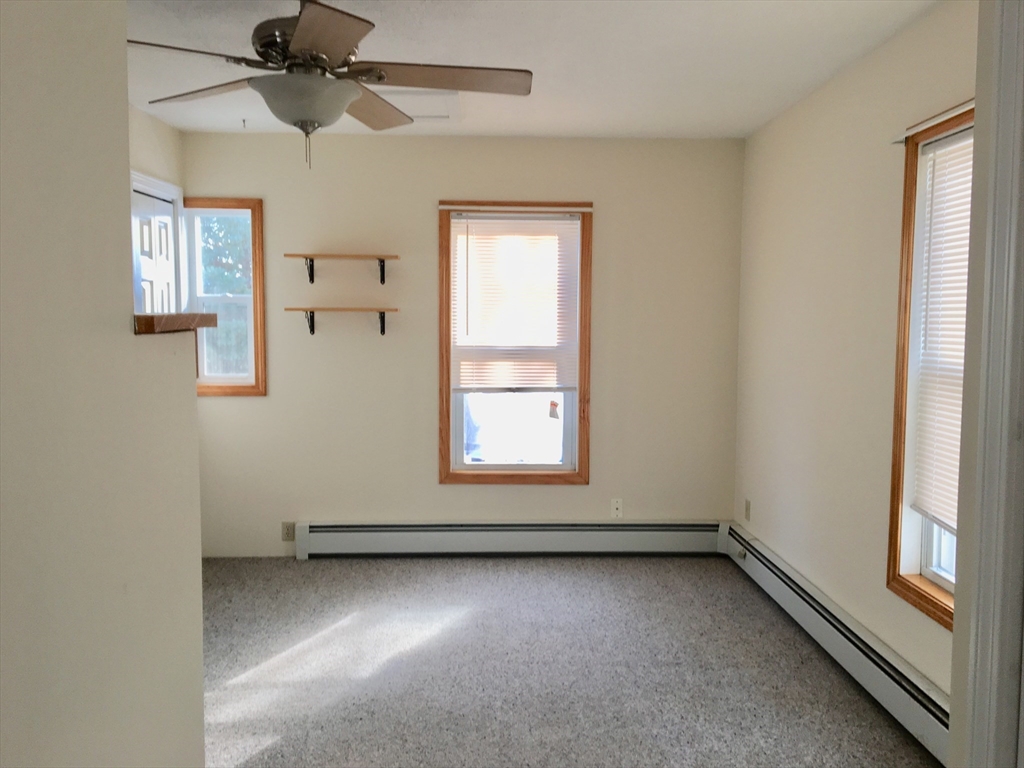 17 Hudson Street, Unit 2 Marlborough, MA 01752 - Photo 4 of 6 an empty room with a window and a ceiling fan