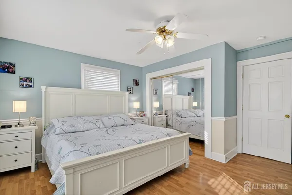 a spacious bedroom with a bed and a chandelier