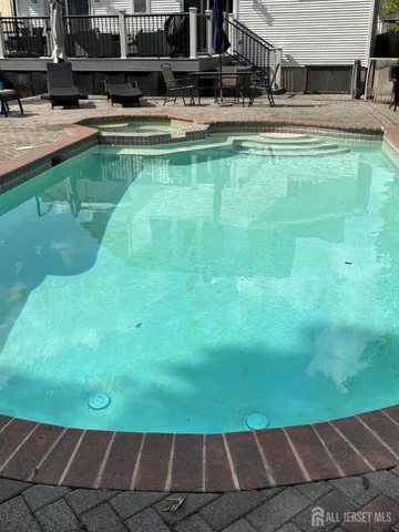 a view of a swimming pool with a yard